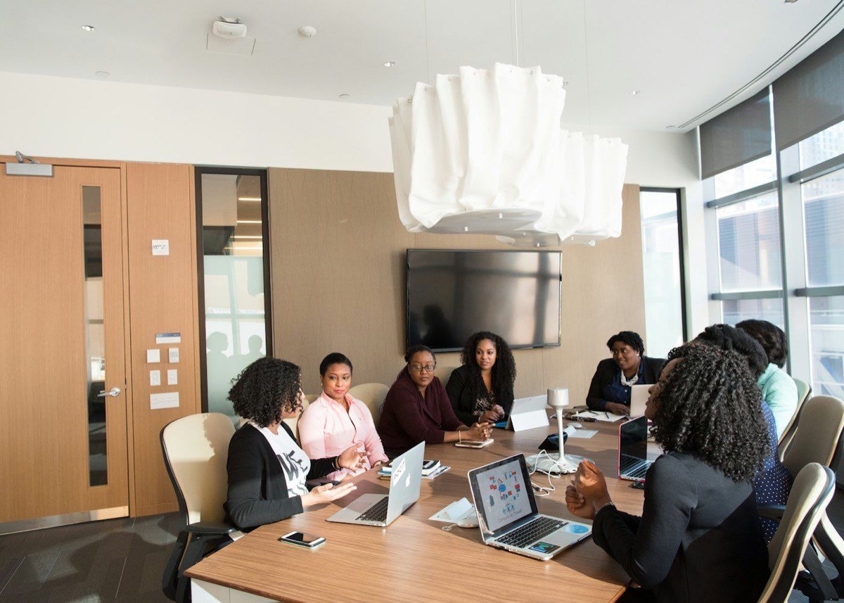 A leader working through a problem with team members at a table